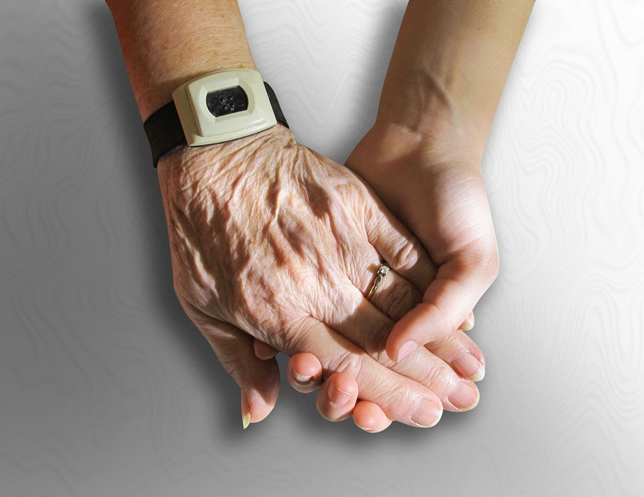 Representative image: caregiver holding elderly hands