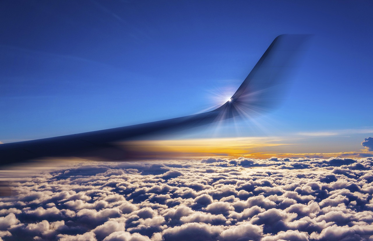 Representative image: airplane wing above clouds
