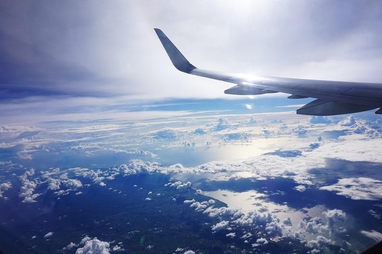Representative image: airplane wing above clouds