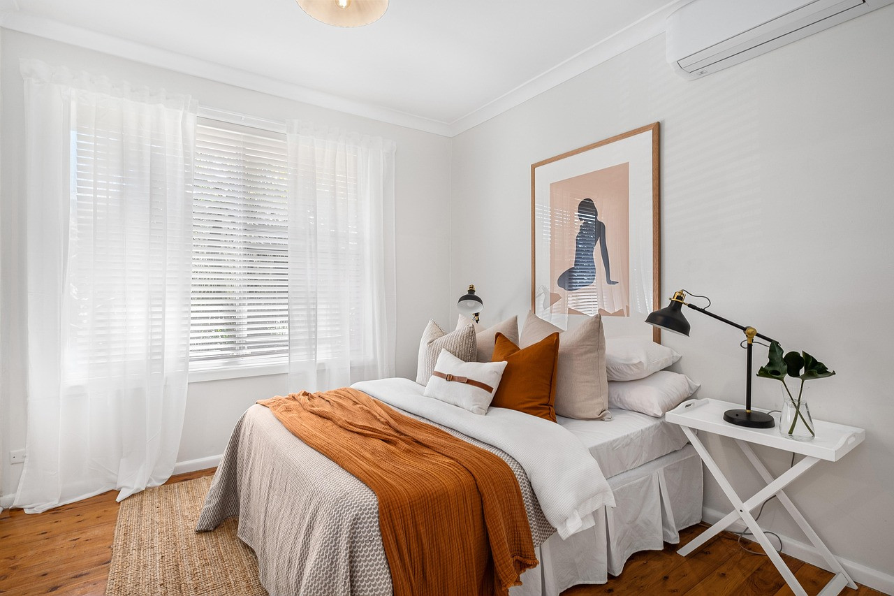 Representative image: made bed in apartment bedroom