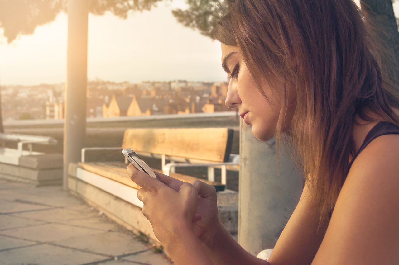 Representative image: young woman filming video on phone