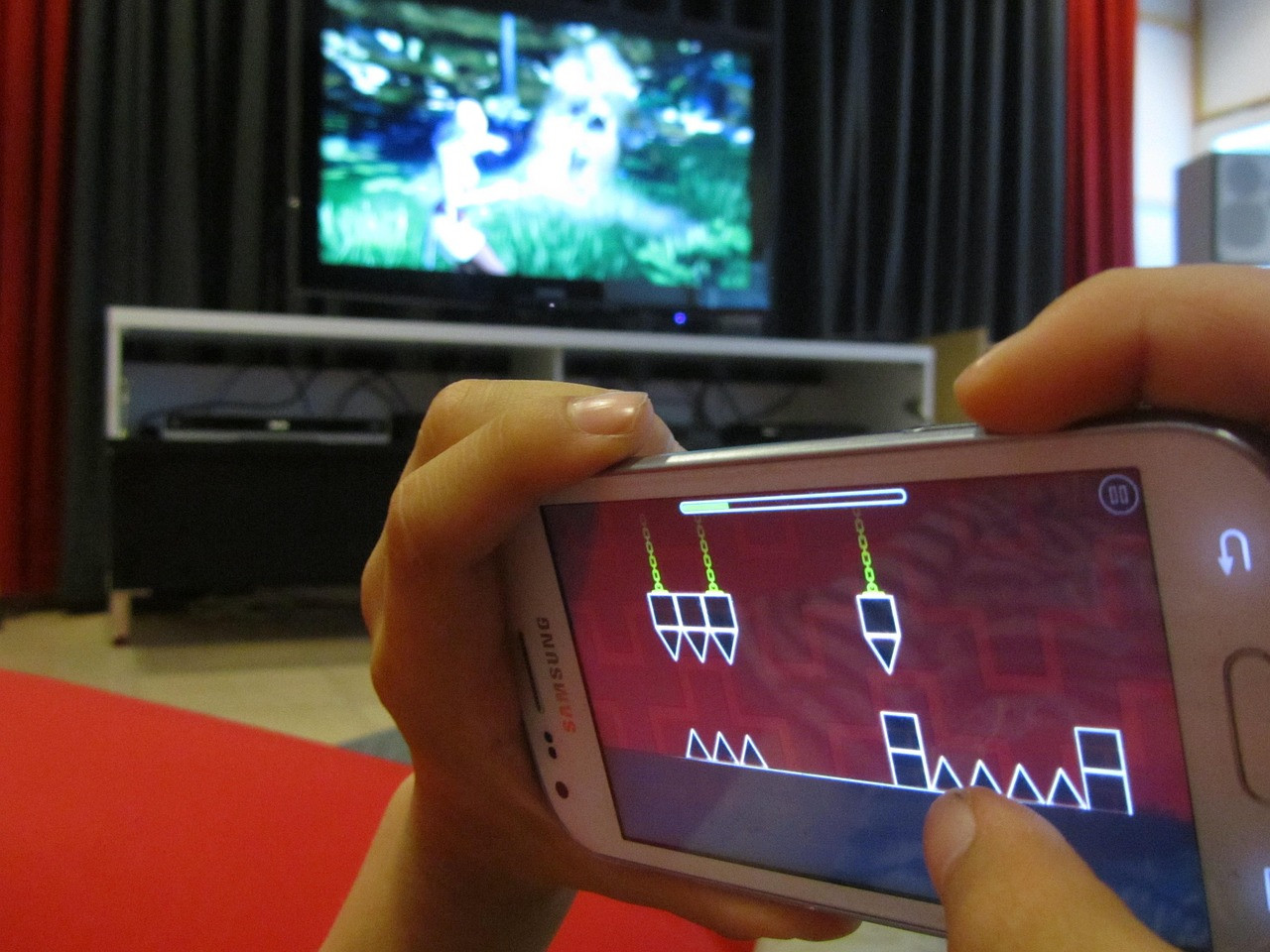 Representative image: hands holding smartphone playing game