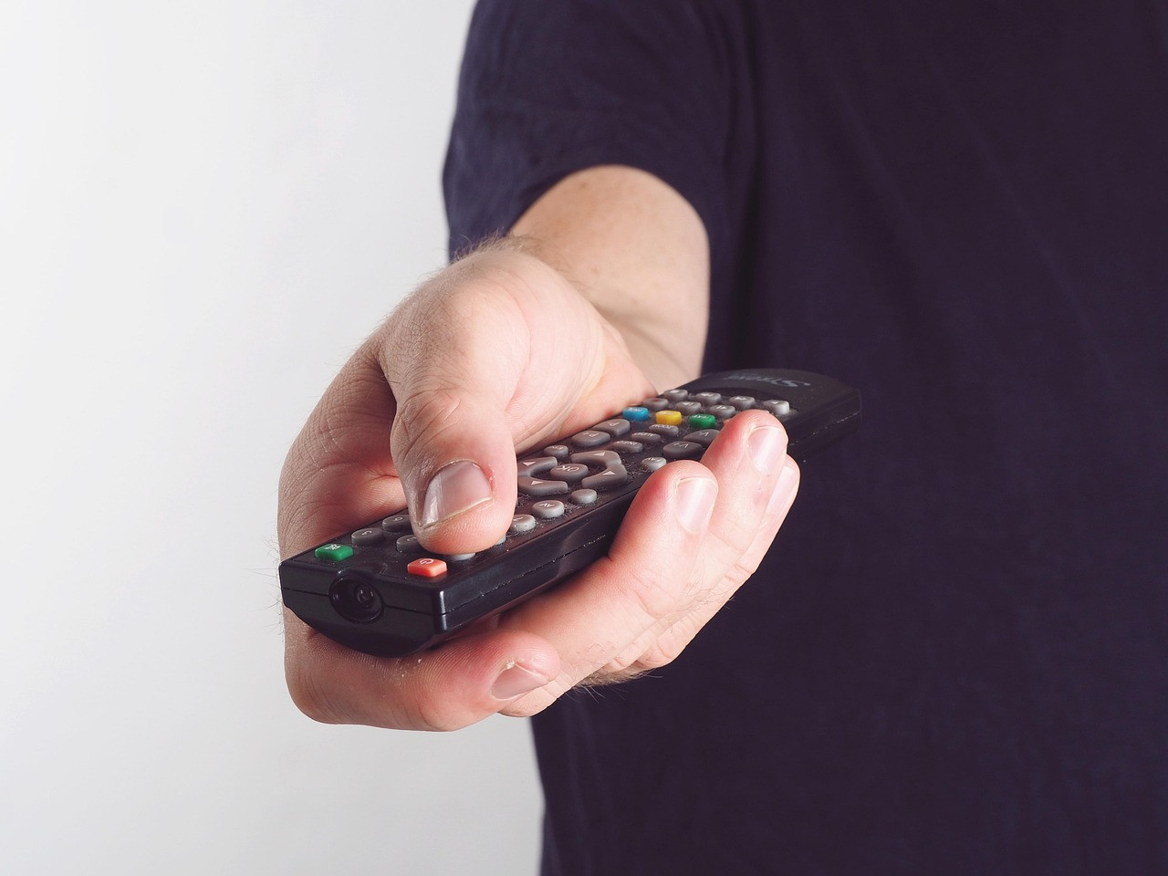 Representative image: television remote control in hand