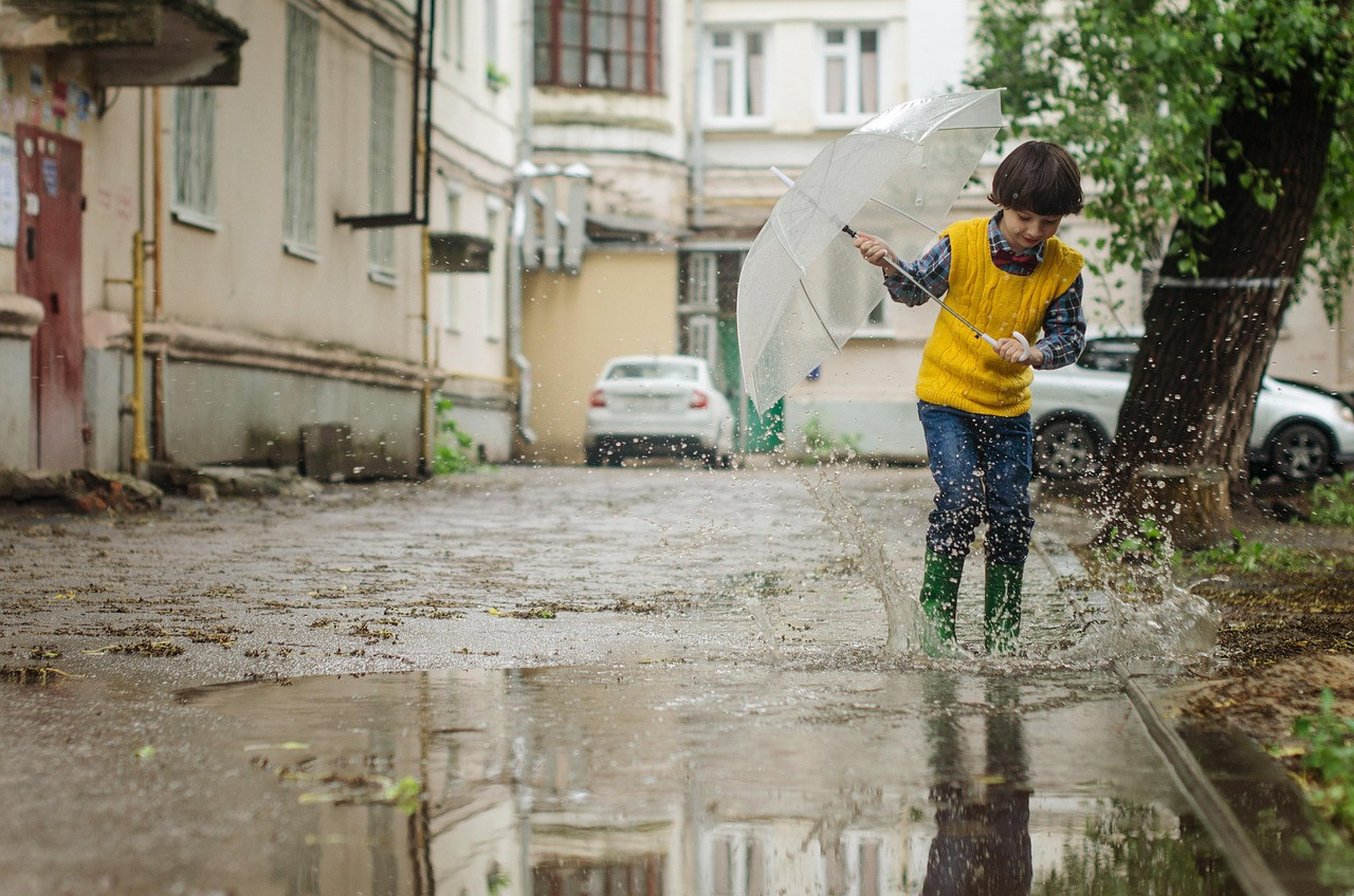 Representative image: school children umbrellas rain