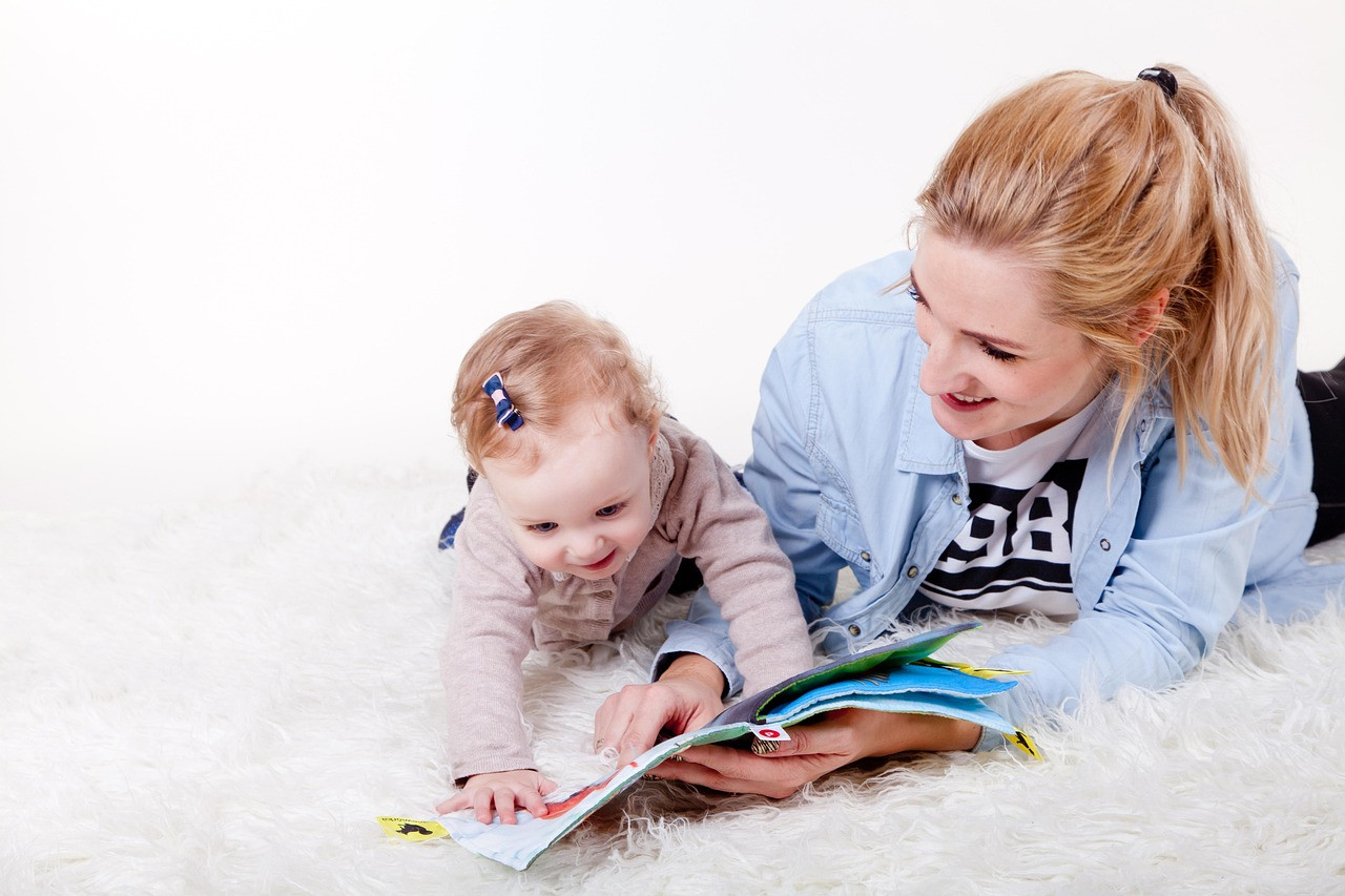 Representative image: parents reading book with child