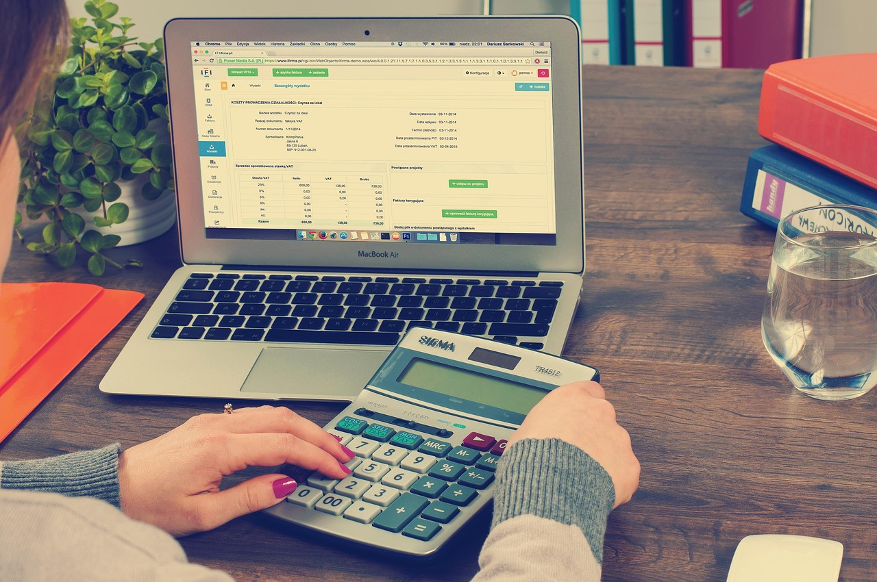 Representative image: accounting ledger calculator desk