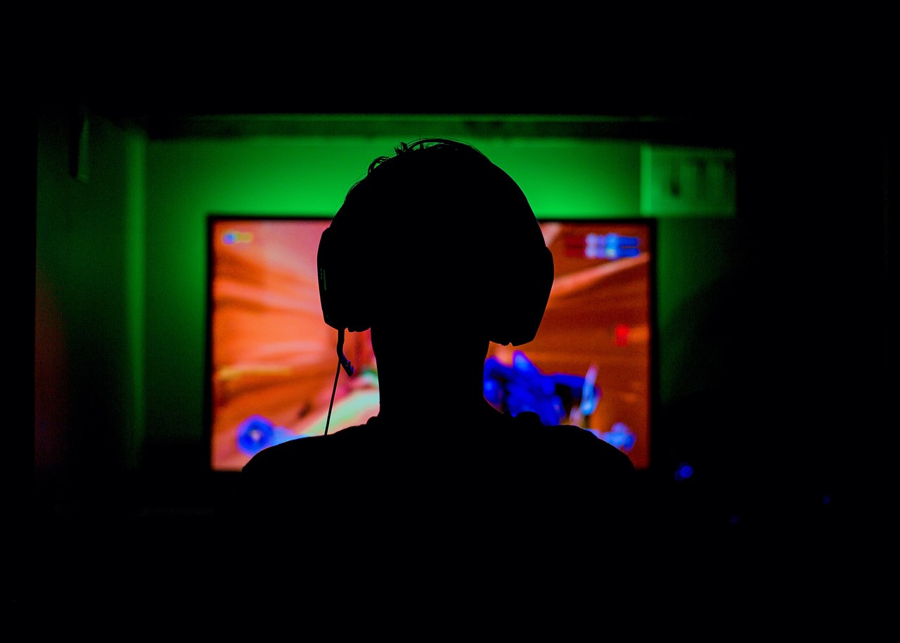 Representative image: gamer with headset playing computer