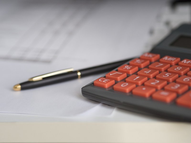 Representative image: invoice calculator office desk