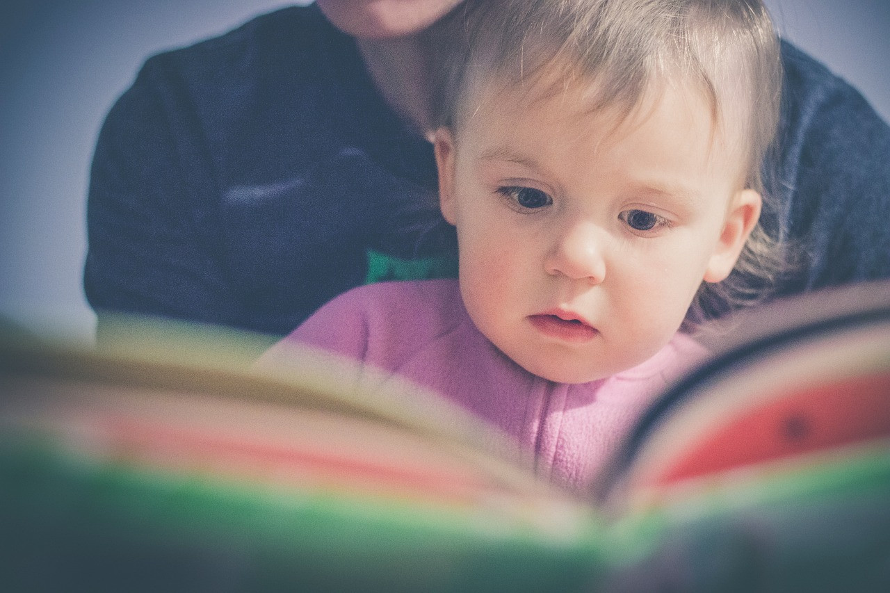 Representative image: parent reading book with child