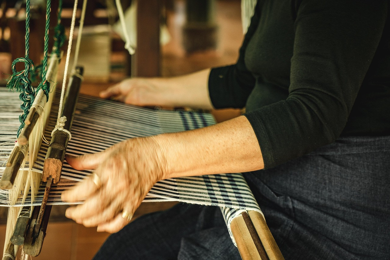 Representative image: woman weaving on handloom