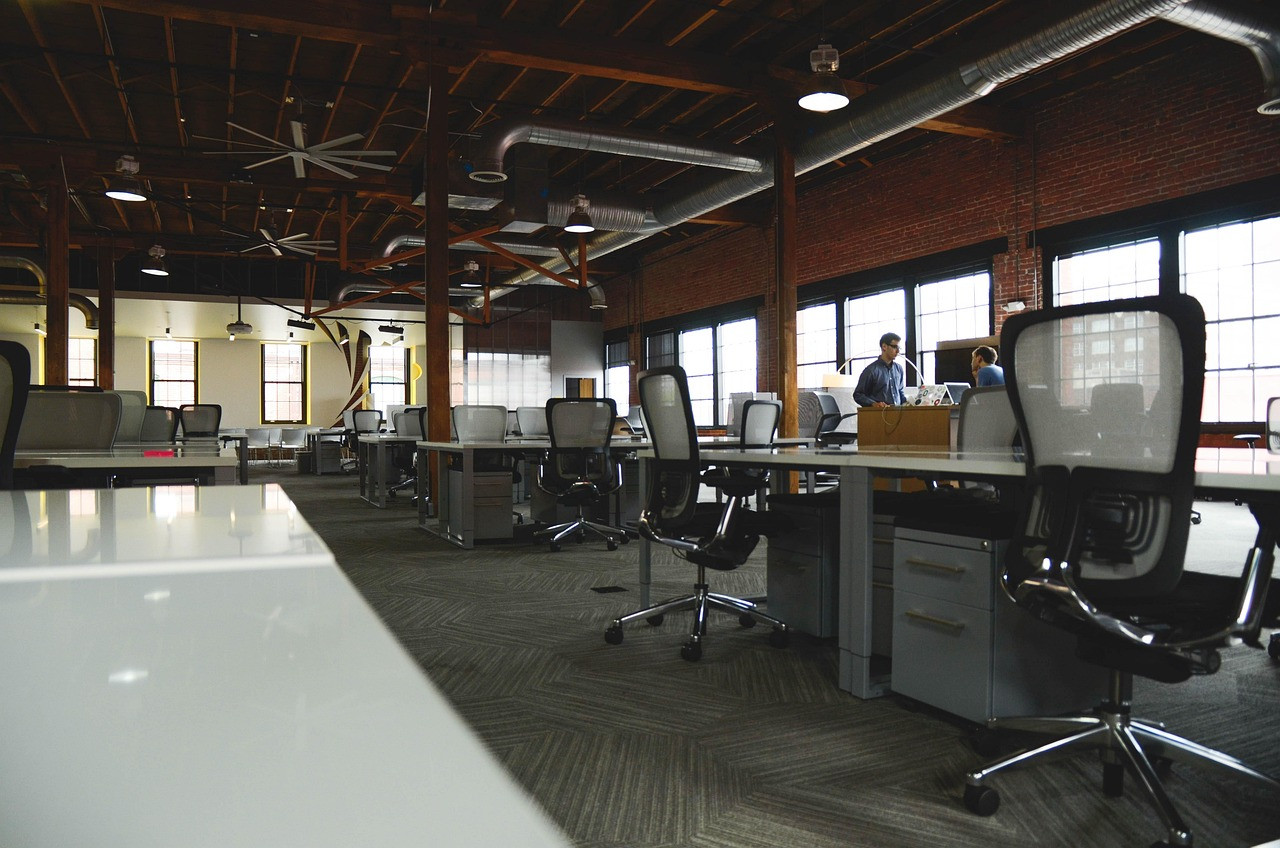 Representative image: empty office desks chairs