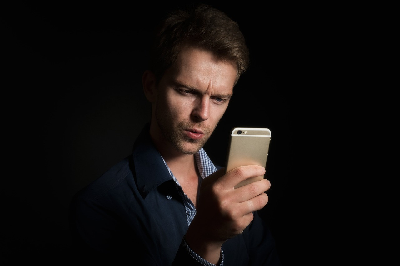 Representative image: person using phone in bed at night