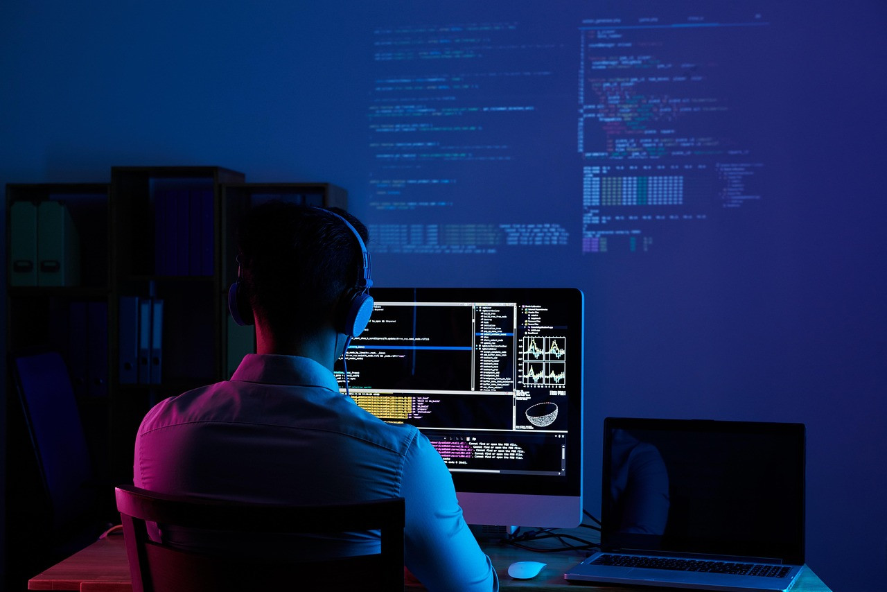 Representative image: young developers coding on laptops