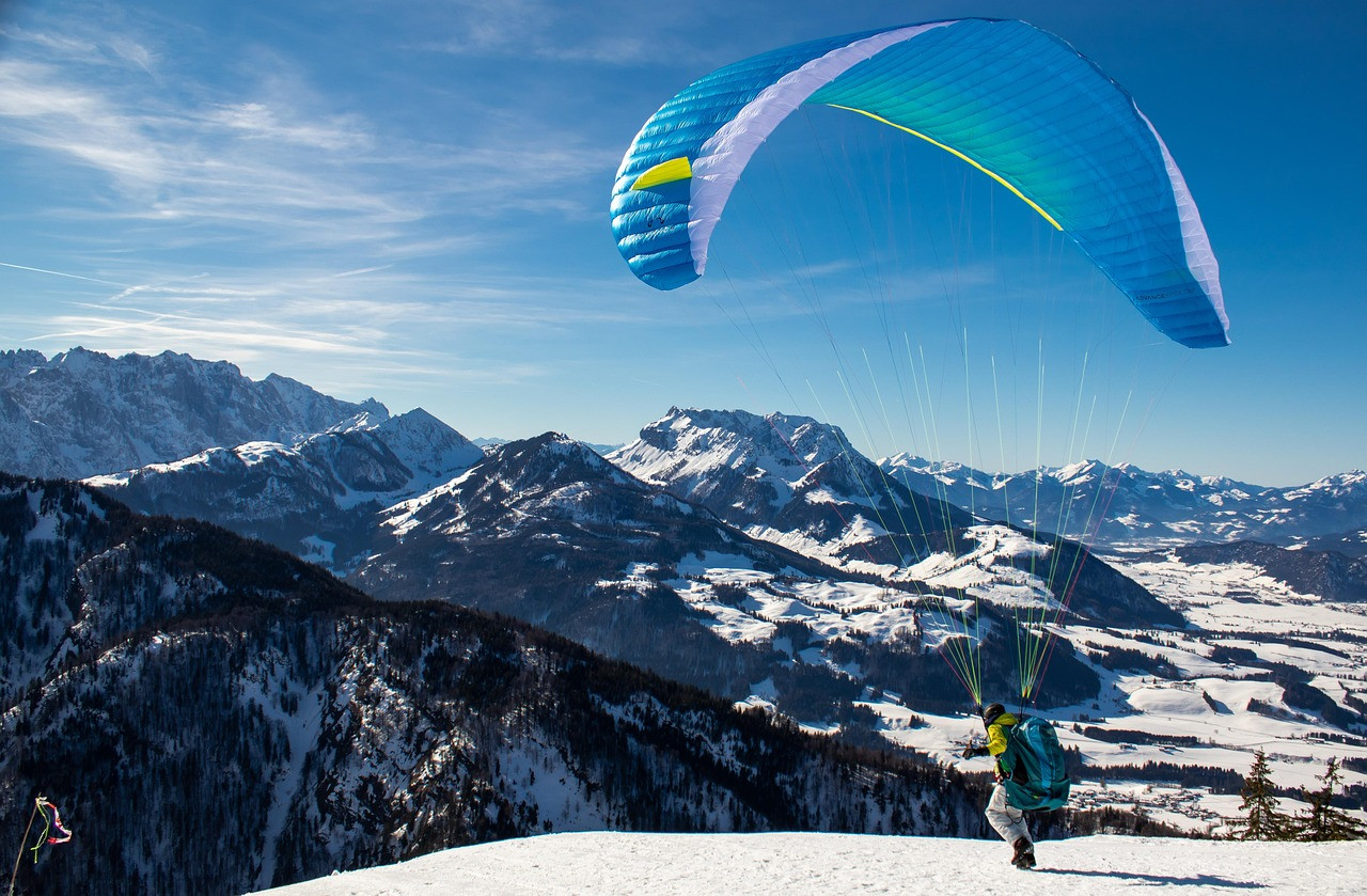 Representative image: paraglider over green mountains