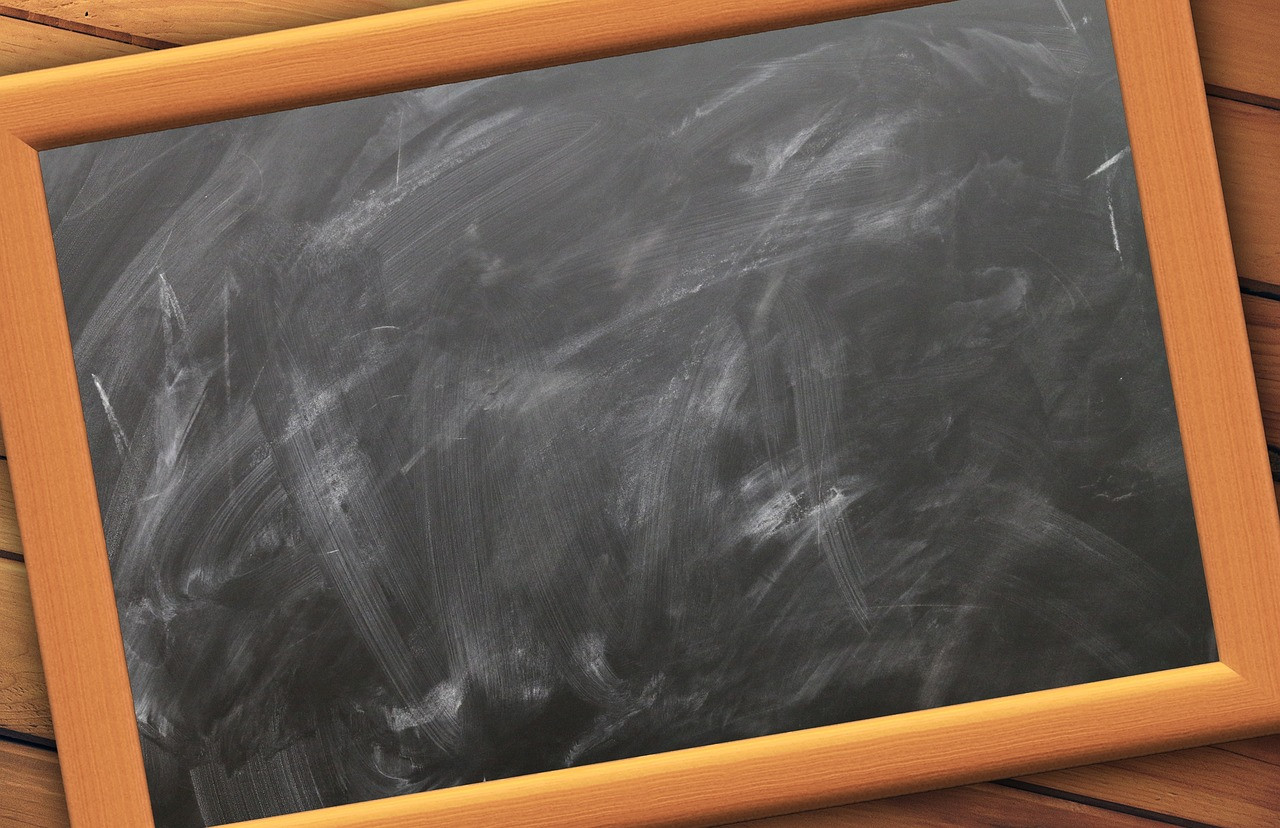 Representative image: teacher writing on blackboard