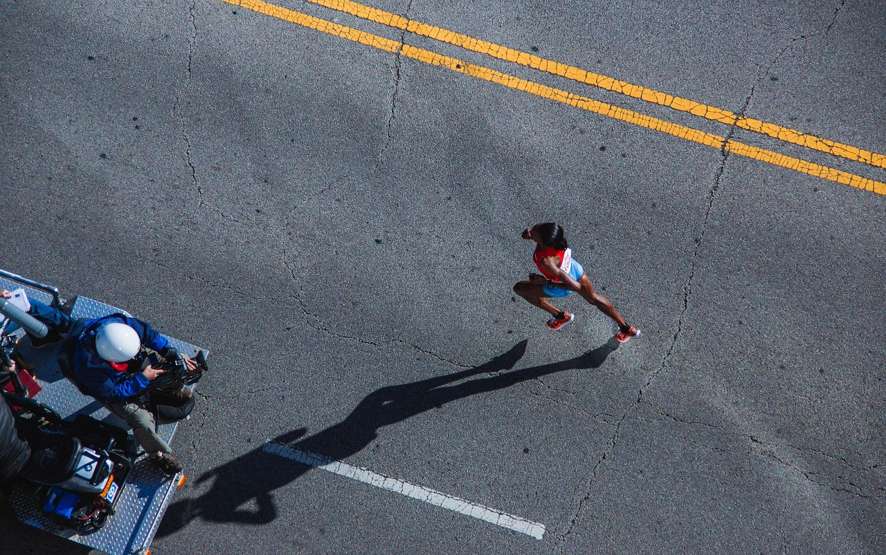 Representative image: people running road race