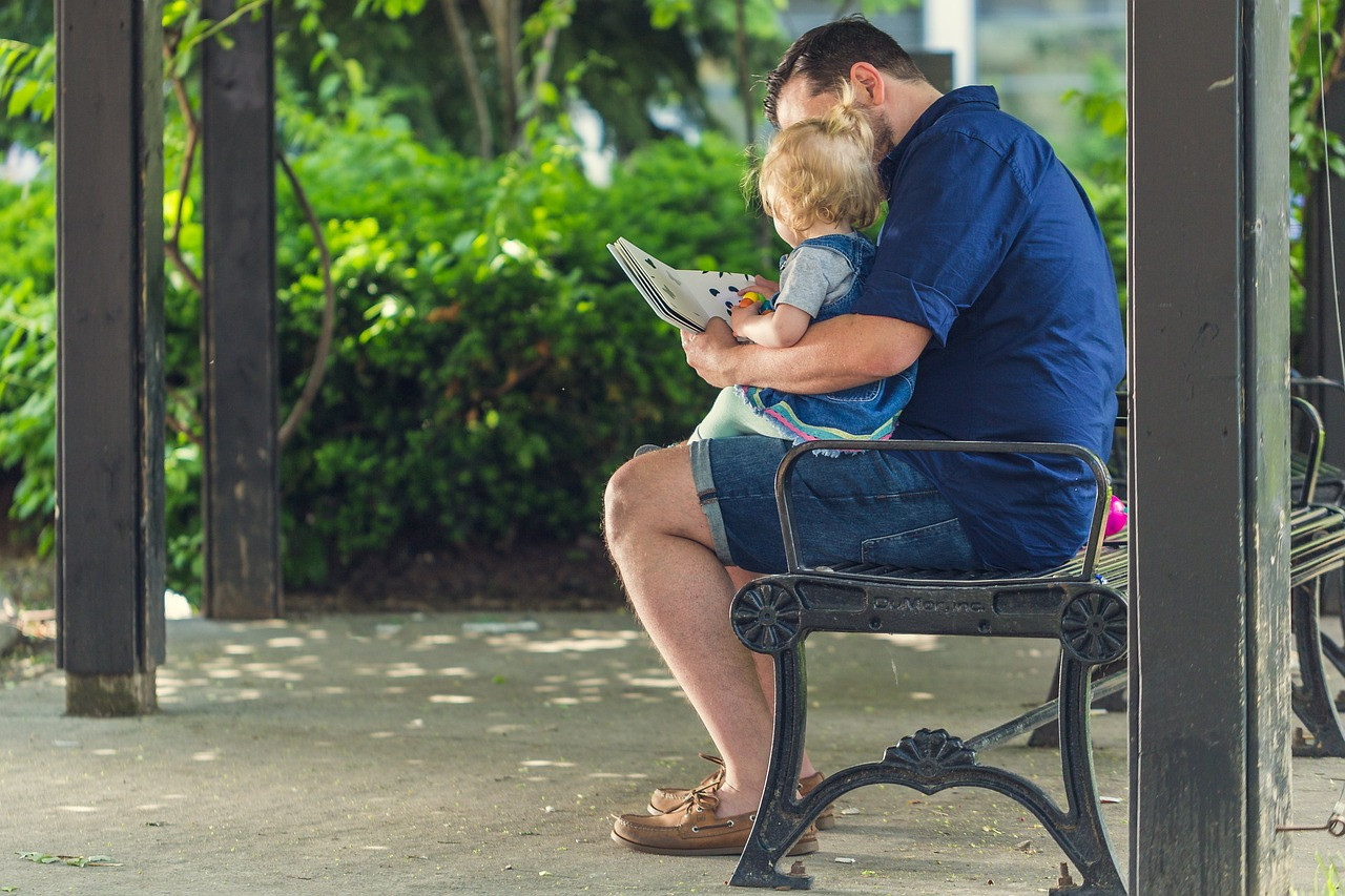 Representative image: parent reading book to toddler