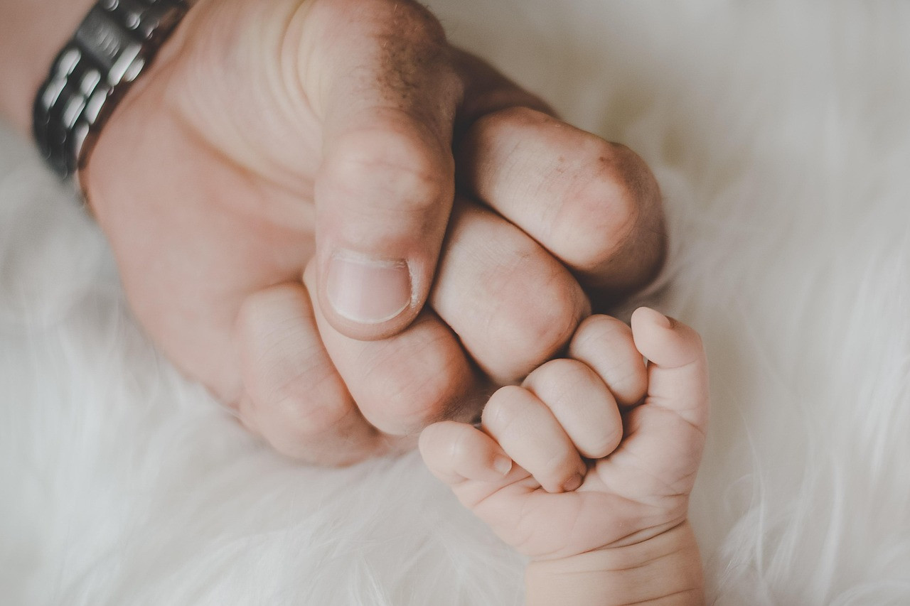 Representative image: father holding newborn baby