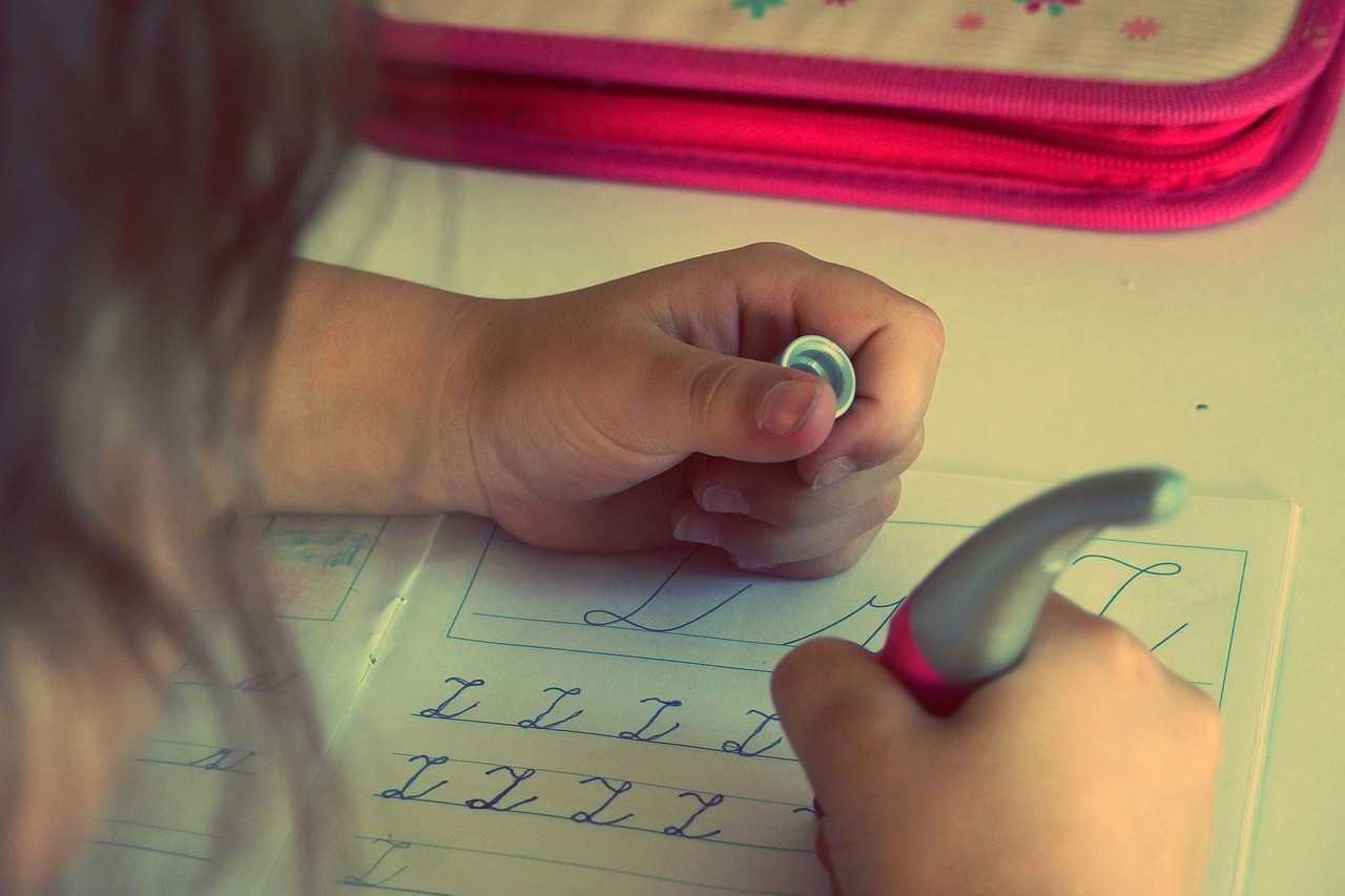 Representative image: child writing alphabet