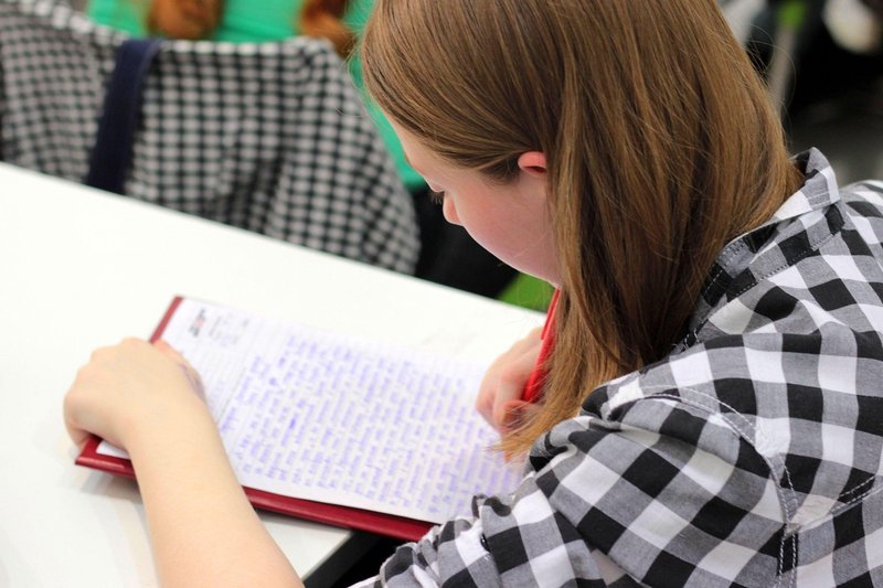 Representative image: student writing essay at desk