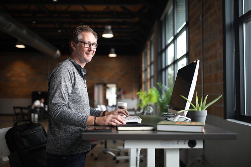 Representative image: coworking office desks people working