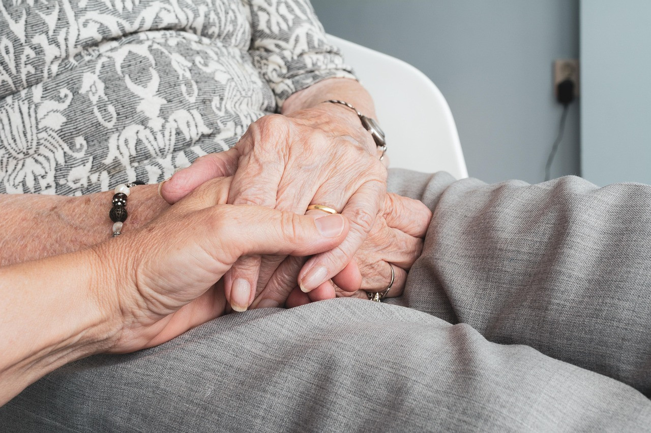 Representative image: woman helping elderly mother
