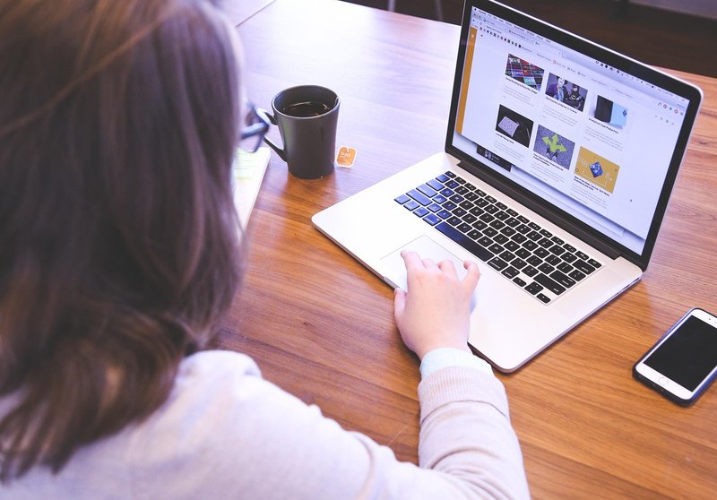 Representative image: woman stretching at office desk