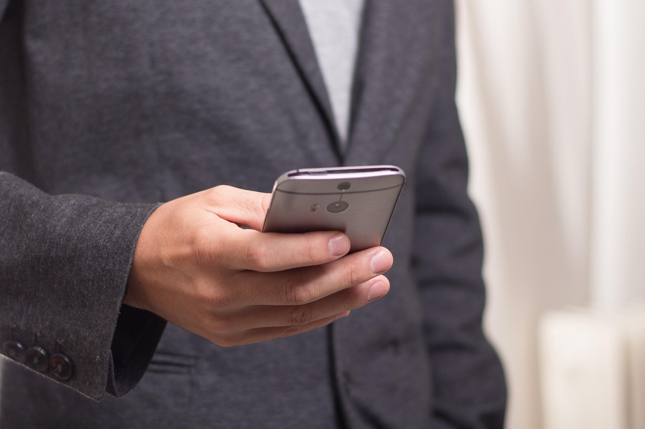 Representative image: worker using smartphone warehouse